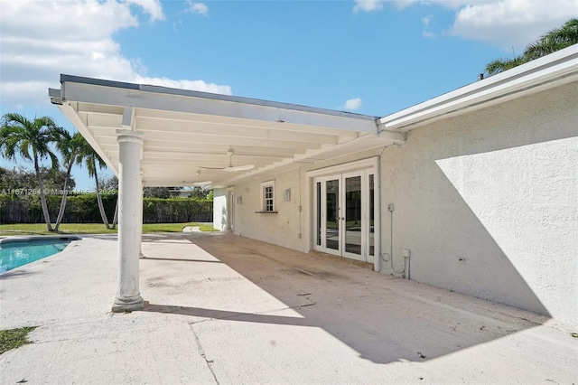 view of patio featuring ceiling fan and french doors