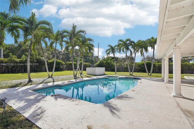 view of swimming pool with a lawn and a patio