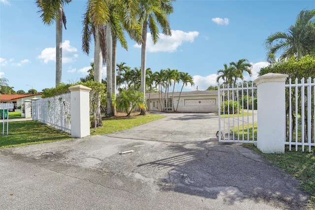 view of gate with a fenced front yard