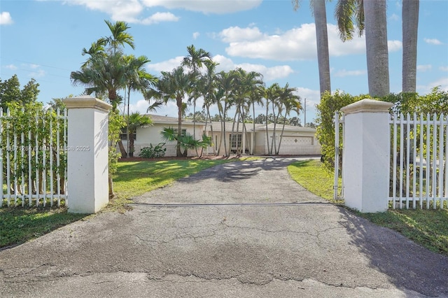 view of gate featuring a yard and fence