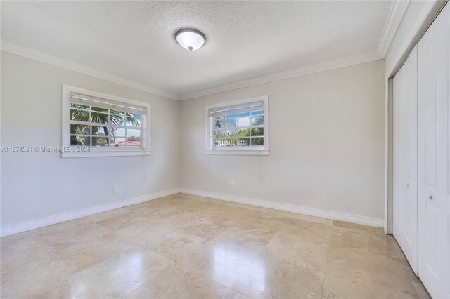 unfurnished bedroom featuring crown molding, a textured ceiling, and a closet