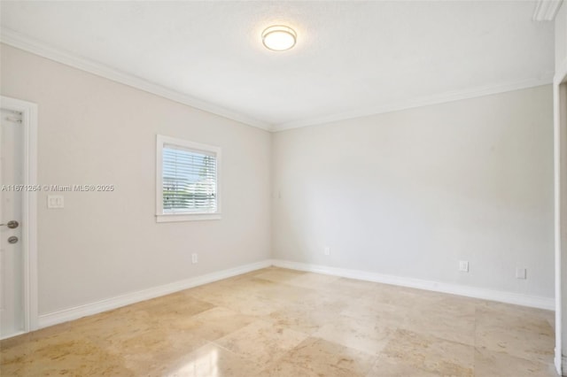 empty room featuring baseboards and ornamental molding