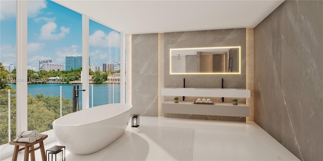 interior space featuring tile walls, a bathing tub, and a water view