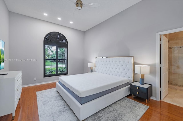 bedroom with ceiling fan, light hardwood / wood-style floors, and ensuite bathroom