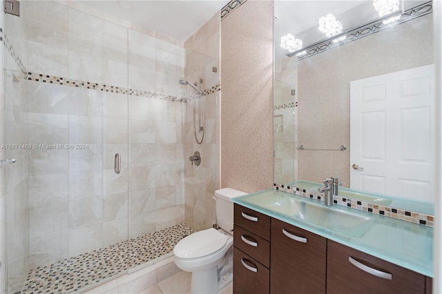 bathroom with vanity, toilet, tile patterned floors, and an enclosed shower