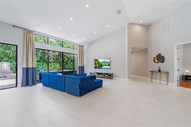 tiled living room featuring high vaulted ceiling