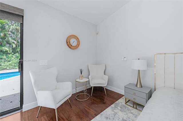 interior space with hardwood / wood-style flooring and lofted ceiling