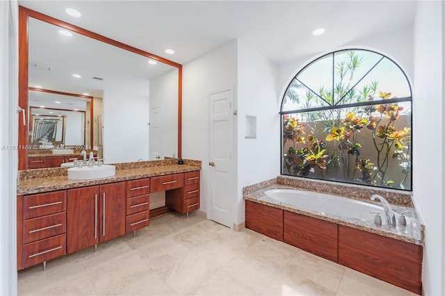 bathroom with vanity and a tub