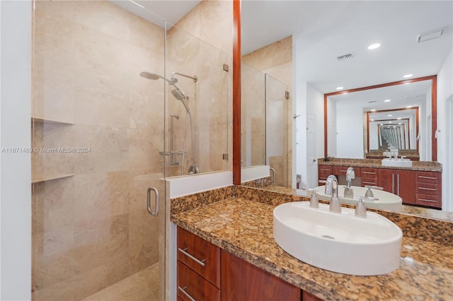 bathroom featuring walk in shower and vanity