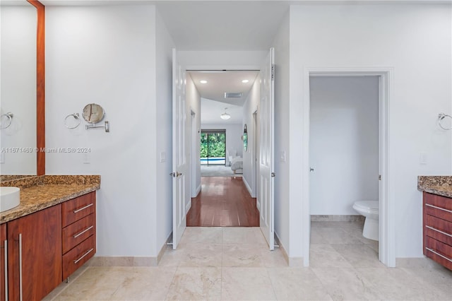 bathroom featuring vanity and toilet