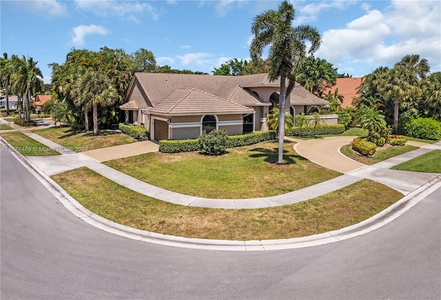 view of front of house with a garage and a front yard