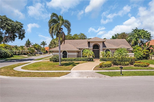 mediterranean / spanish-style house with a front lawn