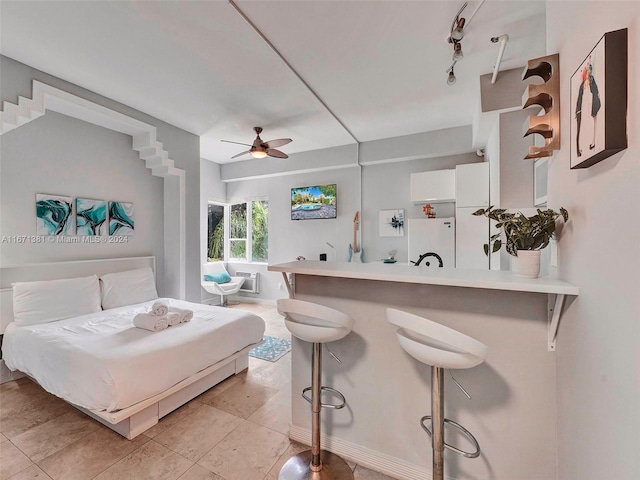 tiled bedroom with ceiling fan and white fridge