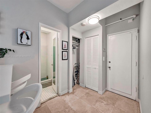 bathroom featuring tile patterned floors and separate shower and tub