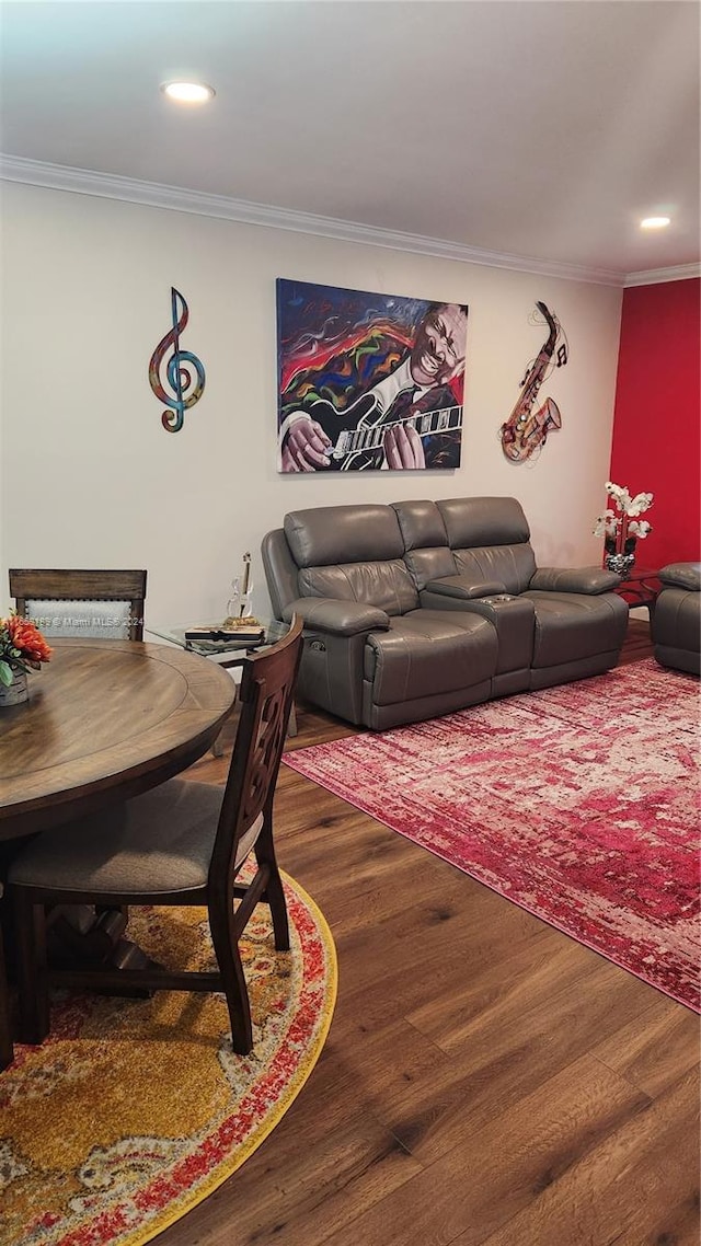 living room with crown molding and dark wood-type flooring