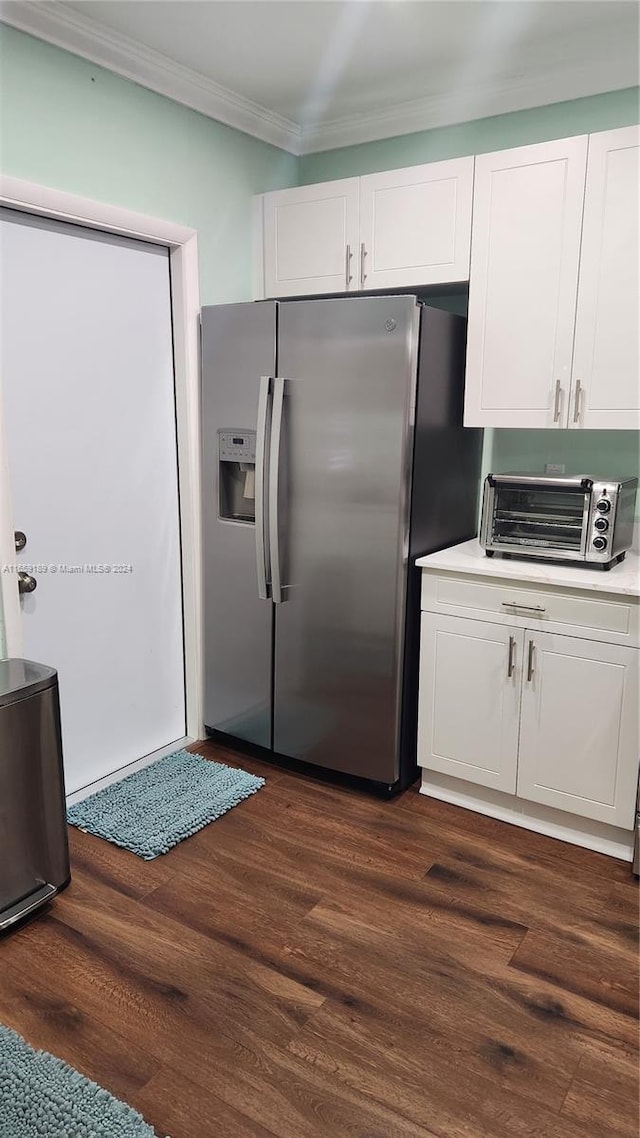 kitchen with white cabinets, stainless steel refrigerator with ice dispenser, dark hardwood / wood-style flooring, and ornamental molding