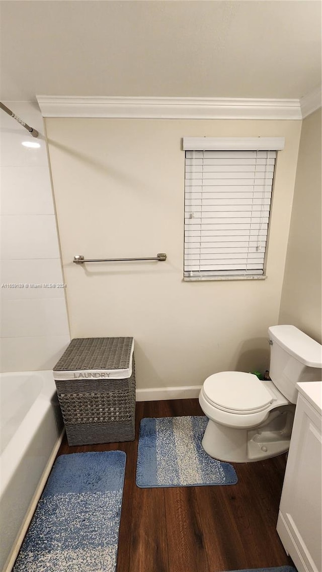 bathroom with ornamental molding, vanity, hardwood / wood-style floors, and toilet