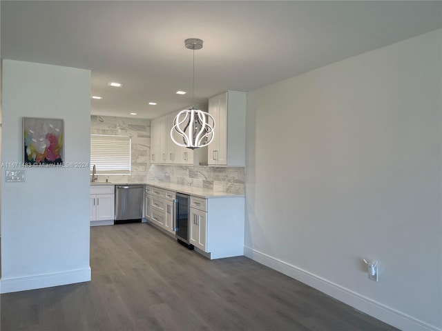 kitchen with hanging light fixtures, white cabinetry, beverage cooler, hardwood / wood-style flooring, and stainless steel dishwasher