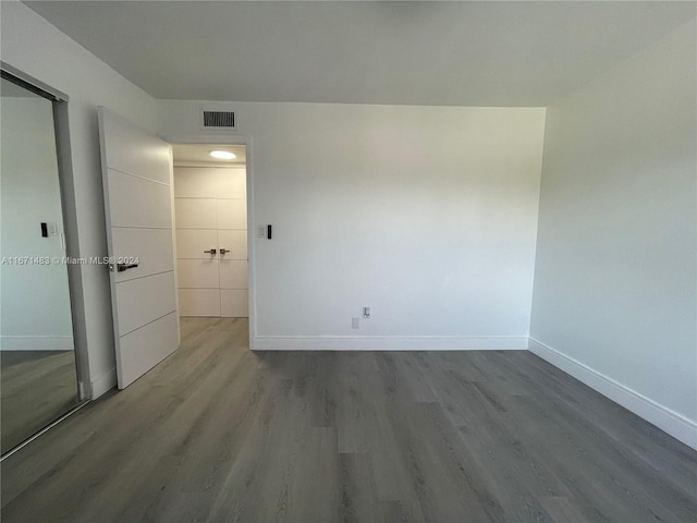 spare room with wood-type flooring