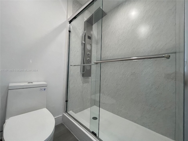 bathroom with walk in shower and toilet