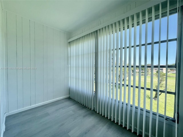 unfurnished room featuring hardwood / wood-style flooring and a healthy amount of sunlight