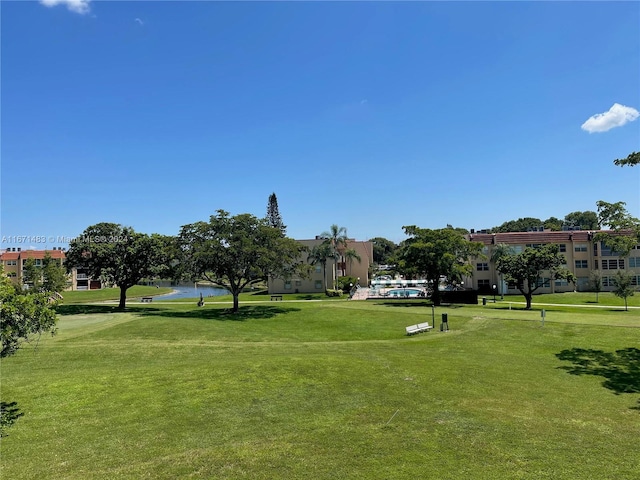 view of home's community featuring a lawn