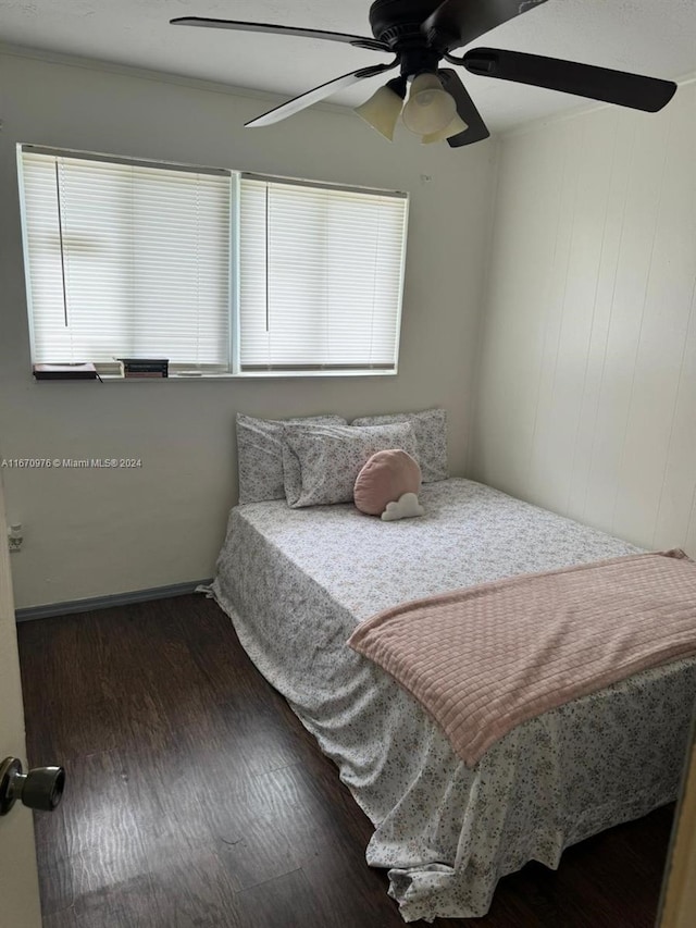 bedroom with dark hardwood / wood-style floors and ceiling fan