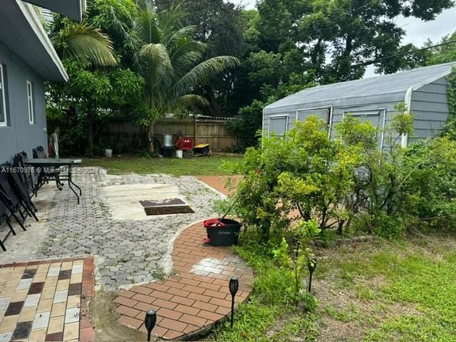 view of yard with a patio and an outbuilding