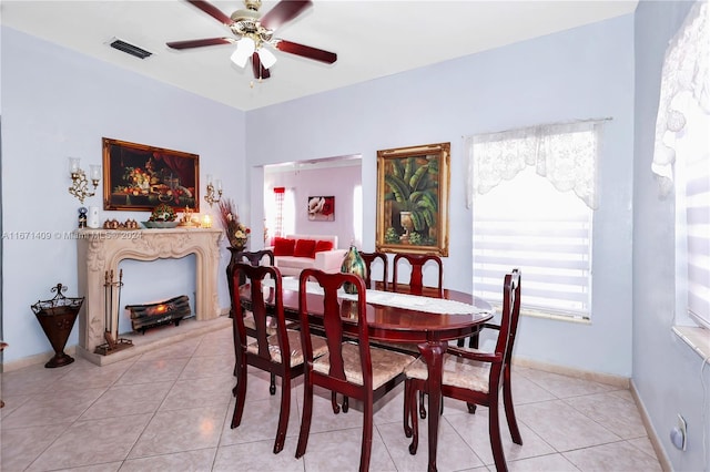 dining space with ceiling fan and light tile patterned floors