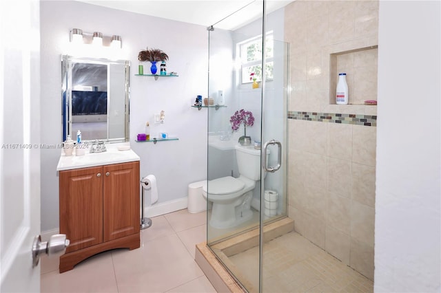 bathroom with tile patterned flooring, vanity, toilet, and a shower with shower door