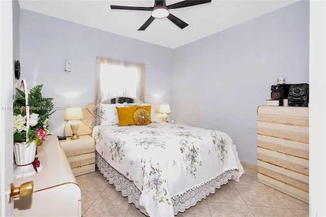 tiled bedroom featuring ceiling fan