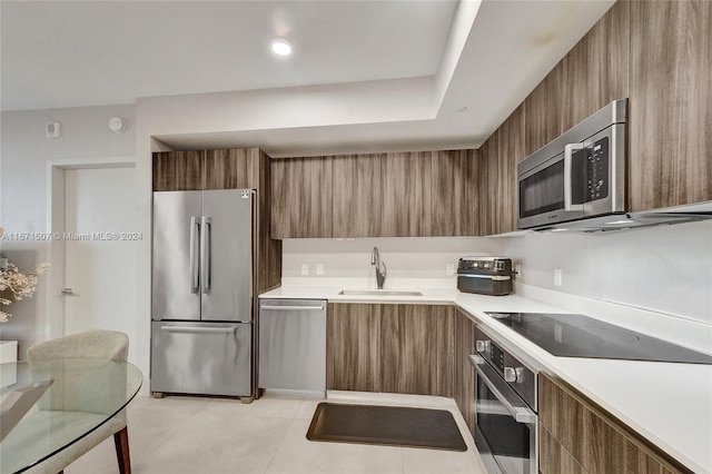 kitchen featuring sink, stainless steel appliances, and light tile patterned floors