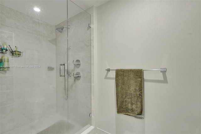 bathroom featuring a shower with door