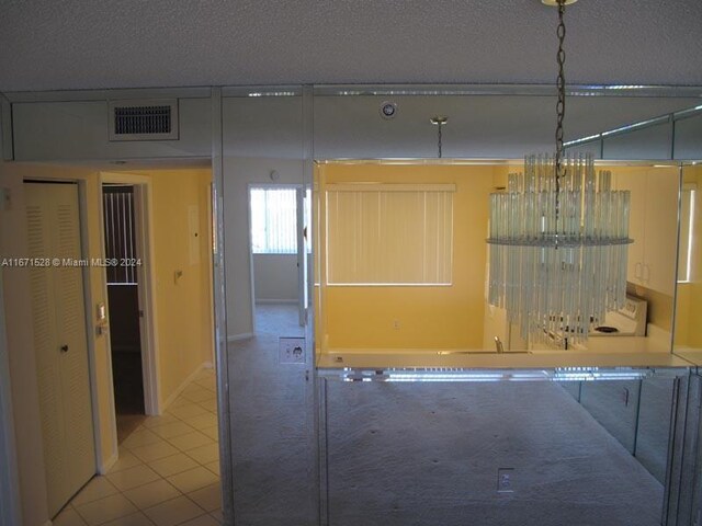 9511 Weldon Cir Unit G402, Tamarac, FL 33321 - hallway featuring a textured ceiling and tile patterned floors