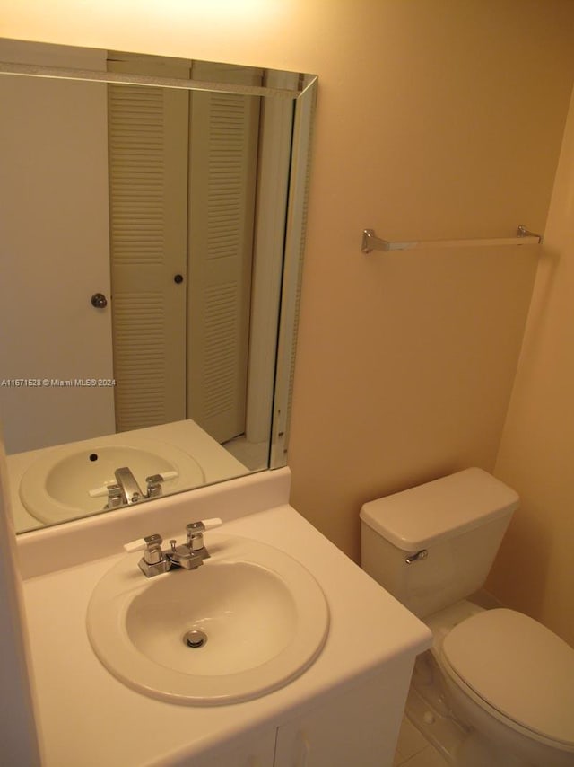 bathroom with sink, tile patterned flooring, and toilet