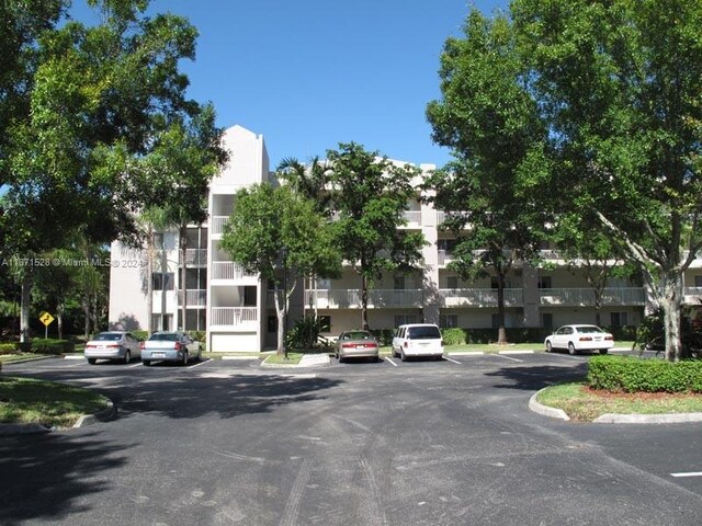 9511 Weldon Cir Unit G402, Tamarac, FL 33321 - view of building exterior with uncovered parking
