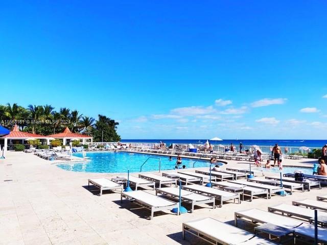 view of swimming pool featuring a water view