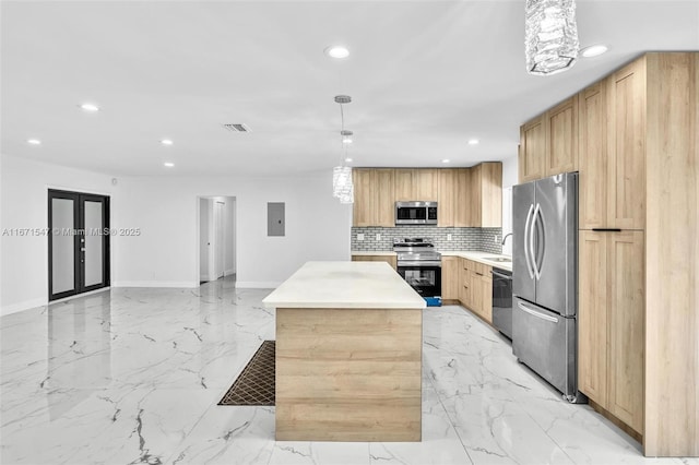 kitchen with decorative backsplash, light brown cabinetry, stainless steel appliances, pendant lighting, and a kitchen island