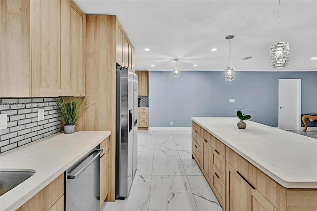 kitchen with stainless steel appliances, pendant lighting, and light brown cabinetry