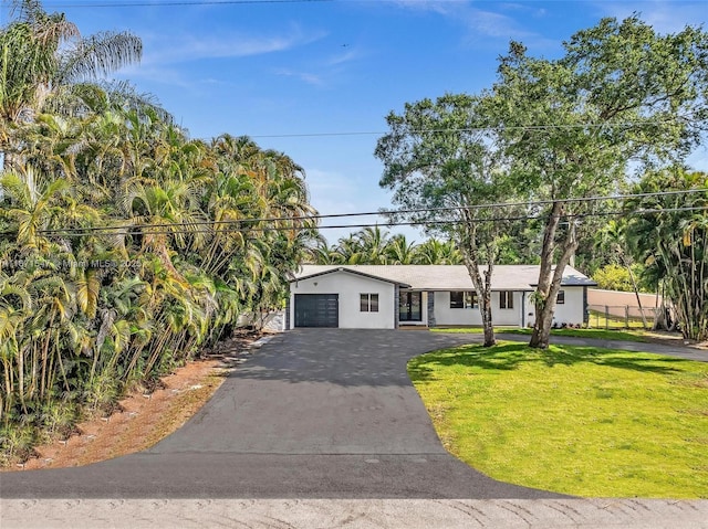 11811 NW 5th Ct, Plantation, FL 33325 - ranch-style house with asphalt driveway, a front lawn, an attached garage, and stucco siding
