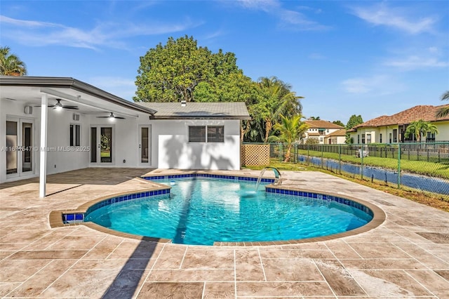 view of pool with pool water feature, ceiling fan, and a patio area