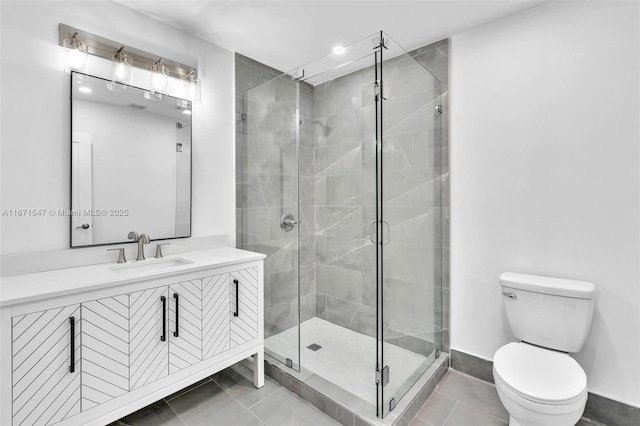 bathroom featuring tile patterned floors, vanity, toilet, and an enclosed shower