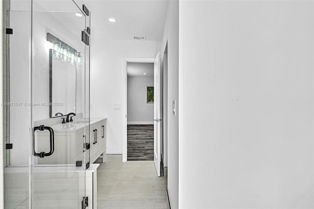 11811 NW 5th Ct, Plantation, FL 33325 - bathroom featuring wood finished floors, recessed lighting, double vanity, and baseboards