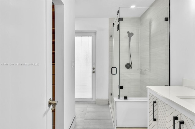 bathroom with vanity and a shower with door