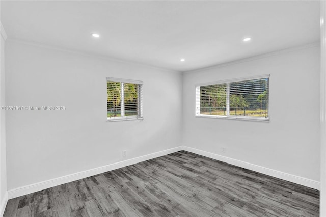 unfurnished room featuring dark wood-type flooring and ornamental molding