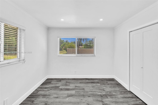 unfurnished room with dark hardwood / wood-style flooring and ornamental molding