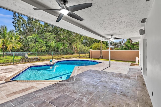 view of pool with ceiling fan and a patio