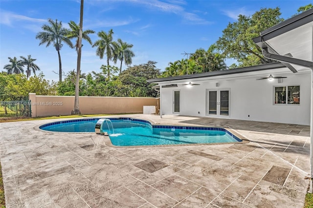 view of pool featuring pool water feature, a patio area, ceiling fan, and french doors