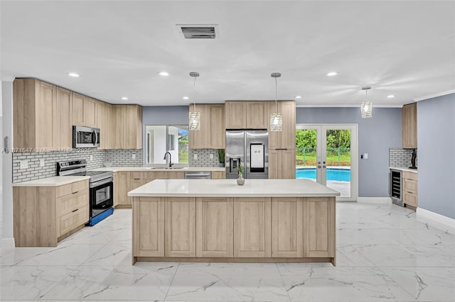 kitchen featuring pendant lighting, appliances with stainless steel finishes, a center island, wine cooler, and light brown cabinetry