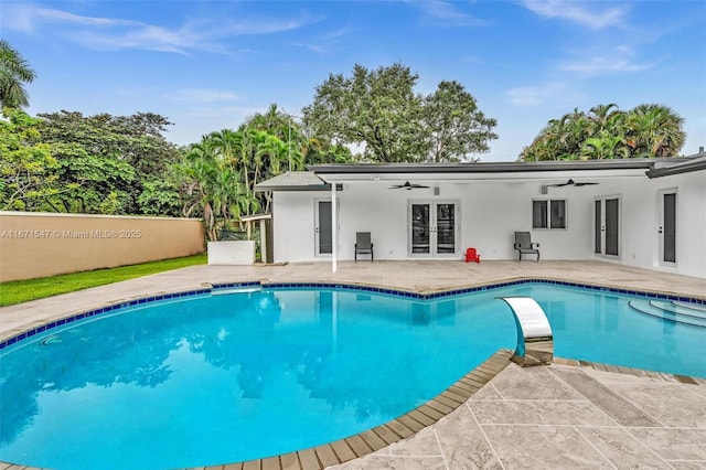 view of pool featuring a patio, ceiling fan, and french doors